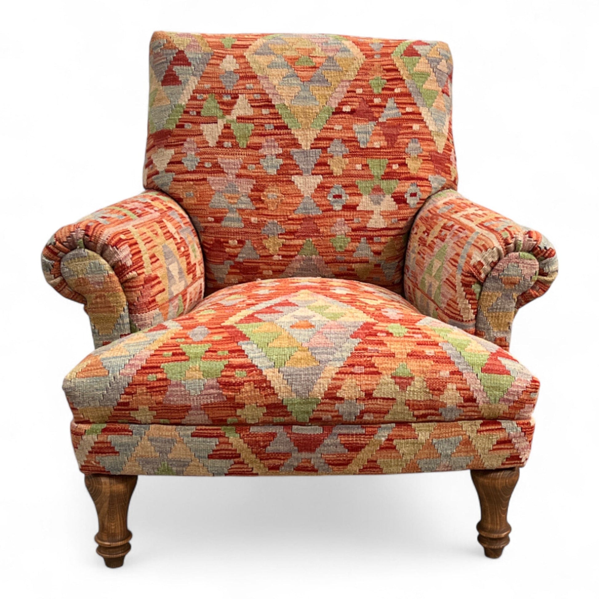 Patterned armchair with wooden legs on a white background