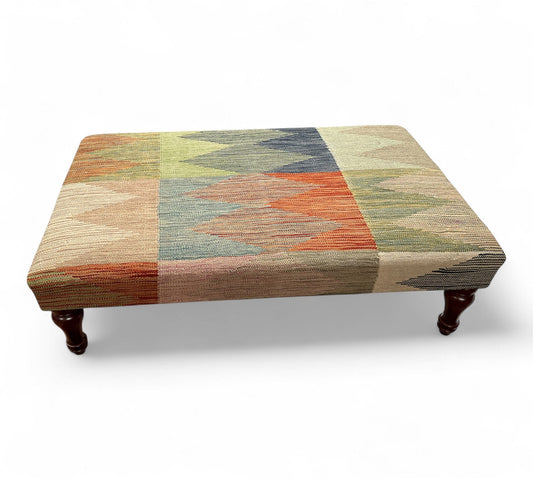 Rectangular ottoman with a multicolored pattern on a white background